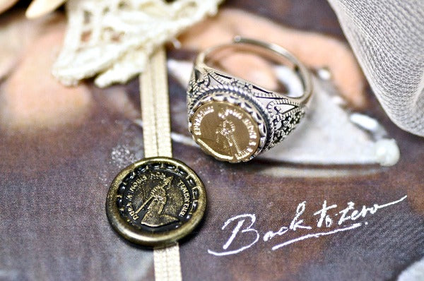 Hand Holding Arrow Latin Motto Lace Signet Ring