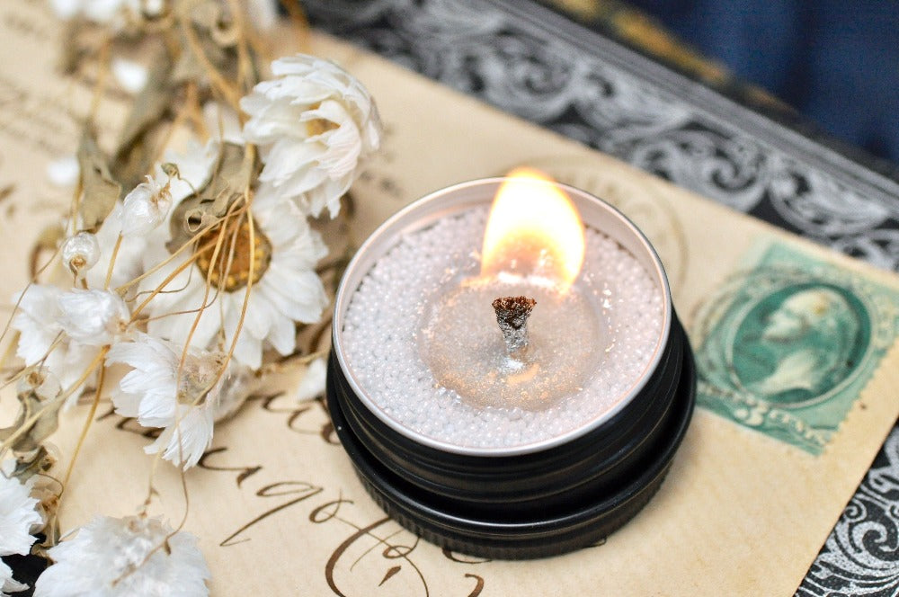 Premium Photo  Lit candle and beads on a tray