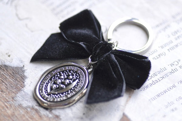 Message Wax Seal Keychain Black Bow | Lily of the Valley - Backtozero B20 - bow, charm, enamel, enamel keychain, Flower, her, keychain, lapel, lily of the valley, metal, ribbon, seashell, soft enamel, starry, velvet, wax seal