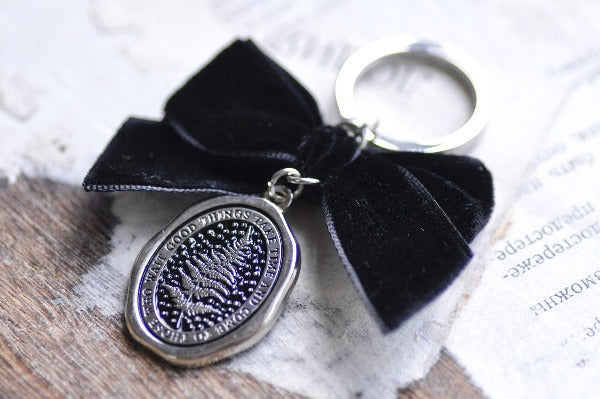 Message Wax Seal Keychain Black Bow | Fern - Backtozero B20 - black bow, botanic, Botanical, bow, charm, Come to those who wait, enamel, enamel keychain, fern, Good things take time, her, keychain, lapel, metal, Nature, Plant, plants, ribbon, silver, soft enamel, starry, velvet, wax seal